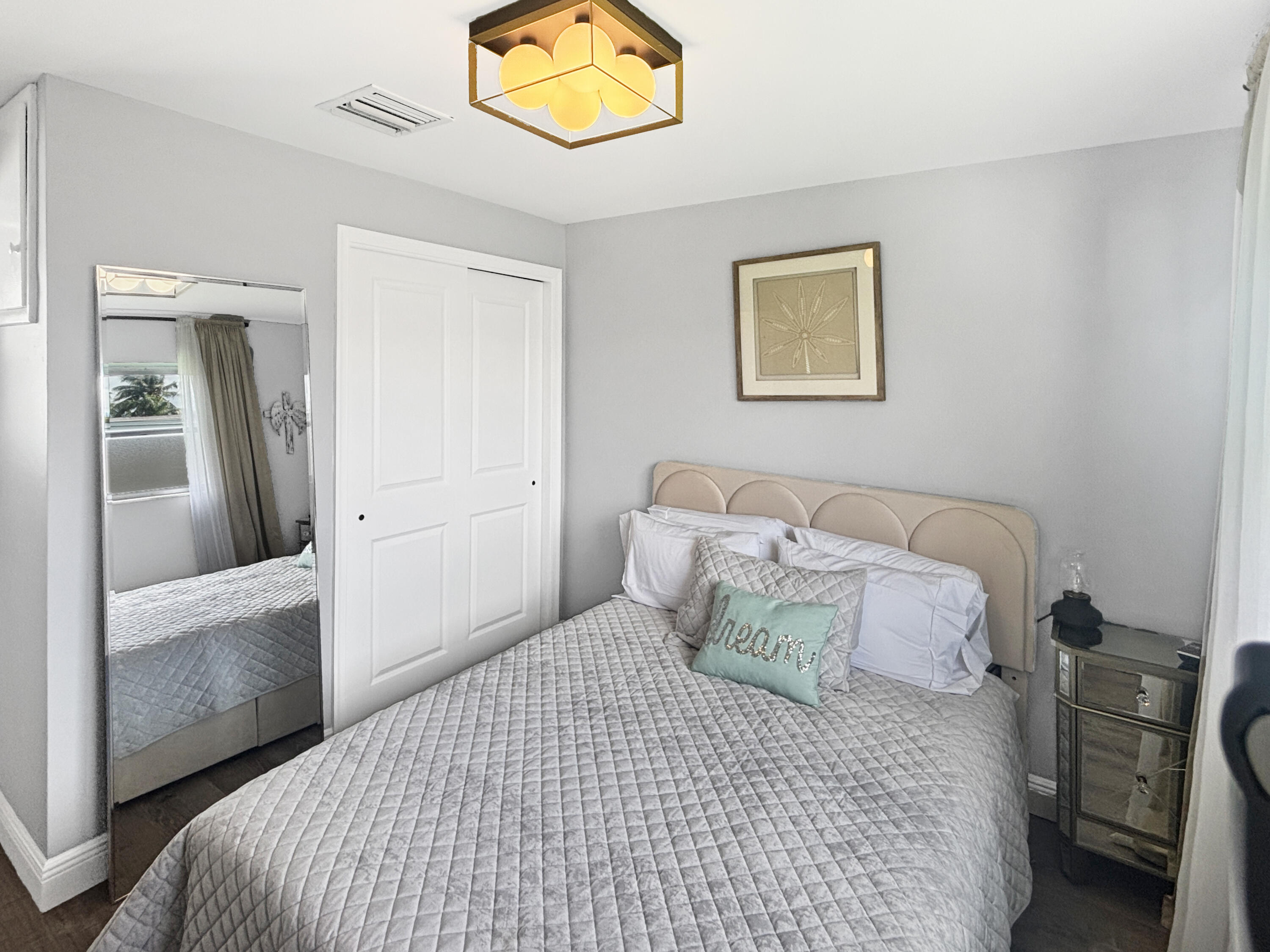 100 Southwest 17th Street Pompano Beach, FL 33060 - Photo 15 of 20 a bedroom with a bed and a mirror