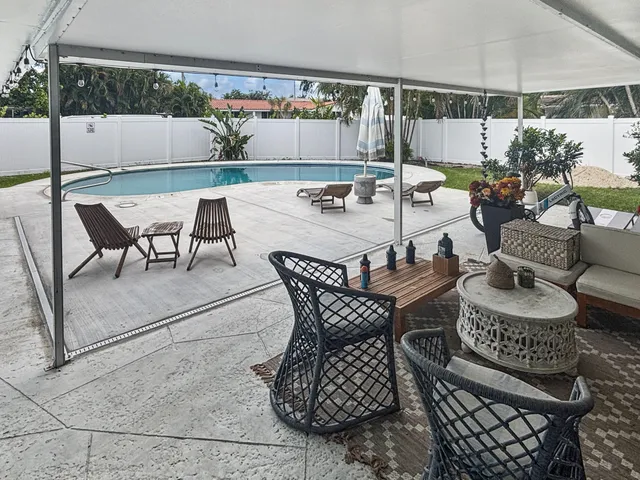 a dining room with furniture and a potted plant