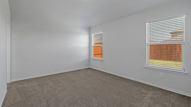 an empty room with a empty space and windows