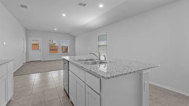 a kitchen with stainless steel appliances granite countertop a sink and a stove