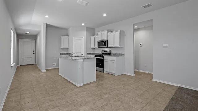 a kitchen with a sink and cabinets