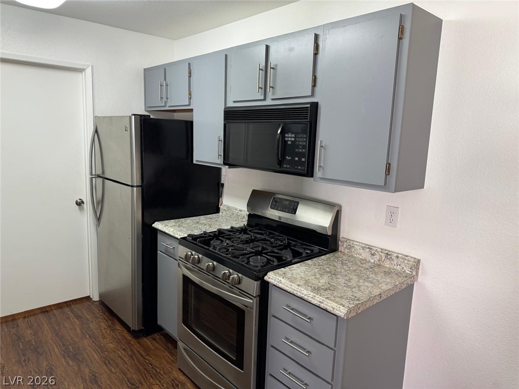 7885 West Flamingo Road, Unit 2171 Las Vegas, NV 89147 - Photo 4 of 22 Compact and functional kitchen offering essential appliances and ample cabinetry.