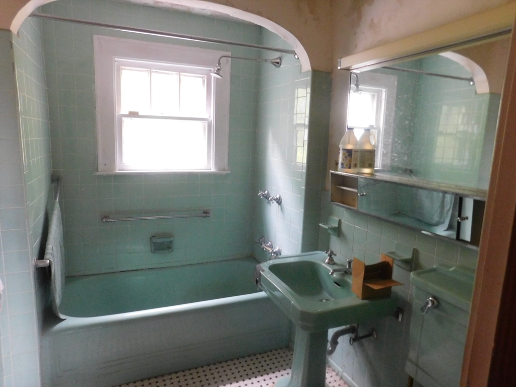 641 Northampton Street Holyoke, MA 01040 - Photo 12 of 19 a bathroom with a bathtub a sink and a window