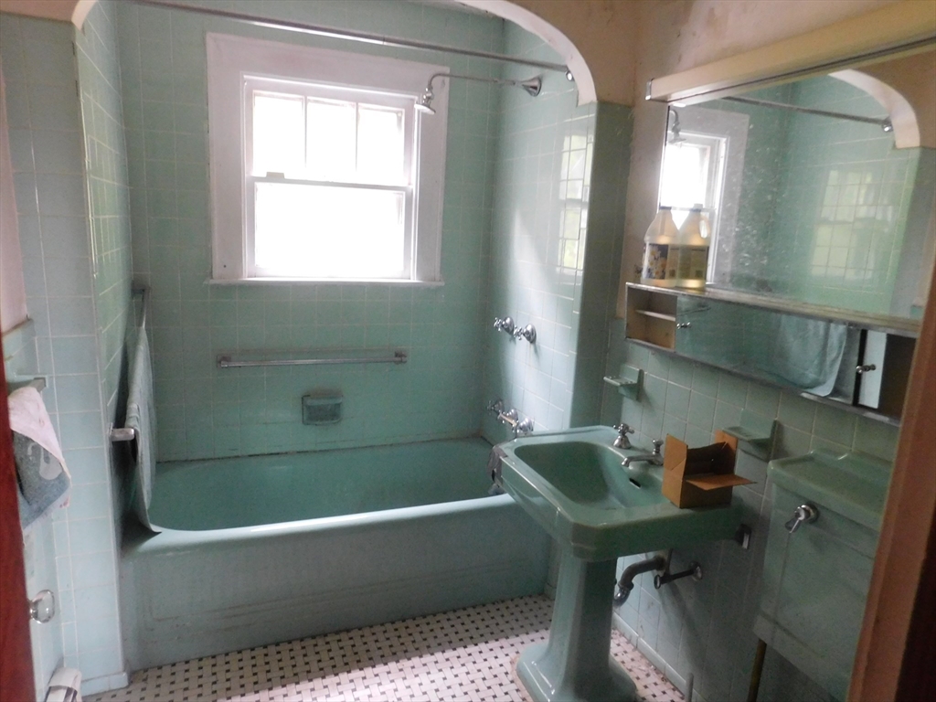 641 Northampton Street Holyoke, MA 01040 - Photo 13 of 19 a bathroom with a tub a sink and a window