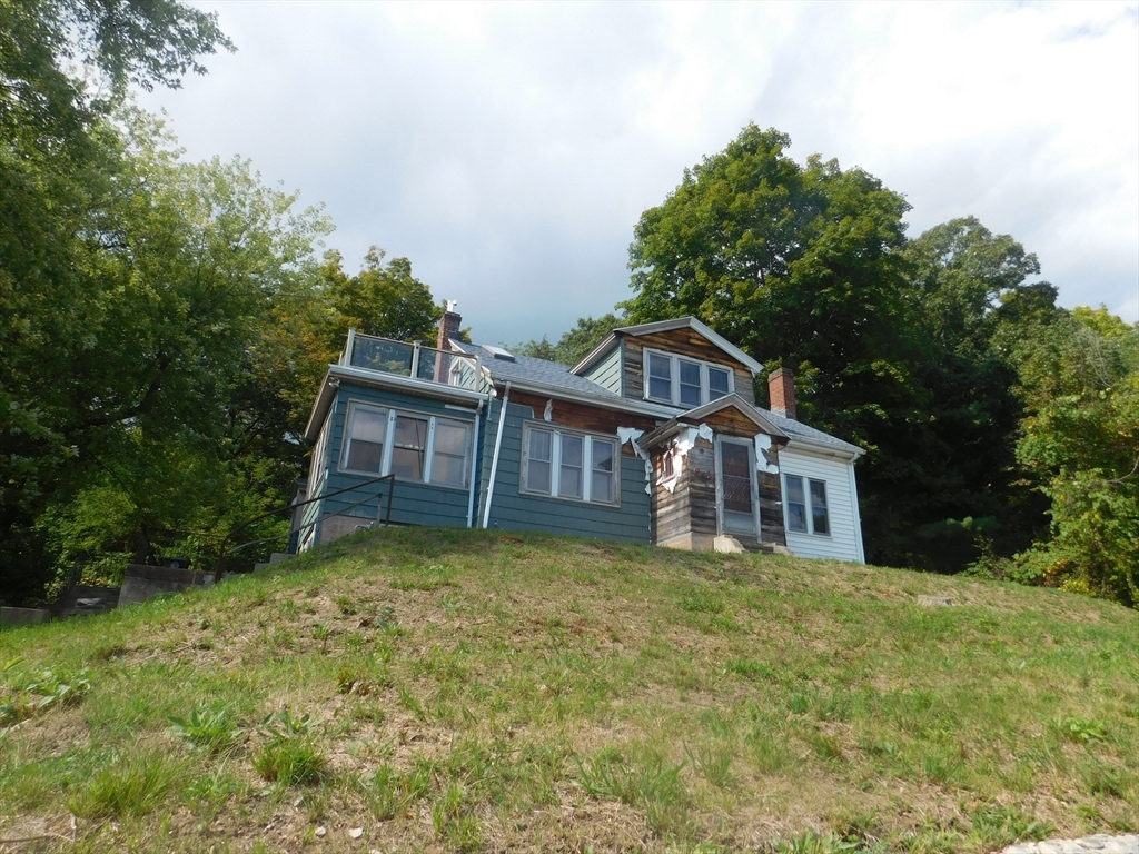 641 Northampton Street Holyoke, MA 01040 - Photo 3 of 19 a view of a house with a big yard and large trees