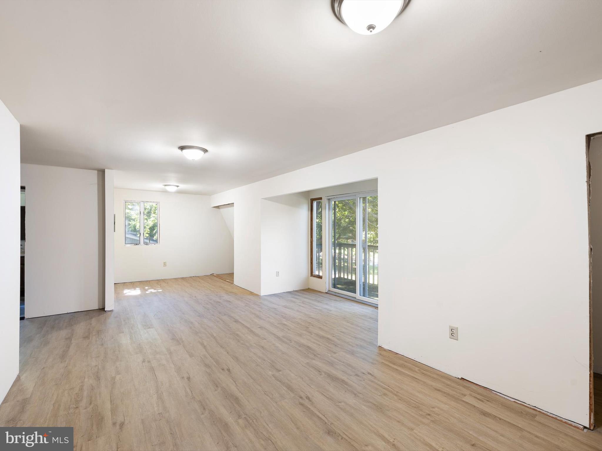 16327 Old Mill Road Lewes, DE 19958 - Photo 18 of 35 an empty room with wooden floor and windows