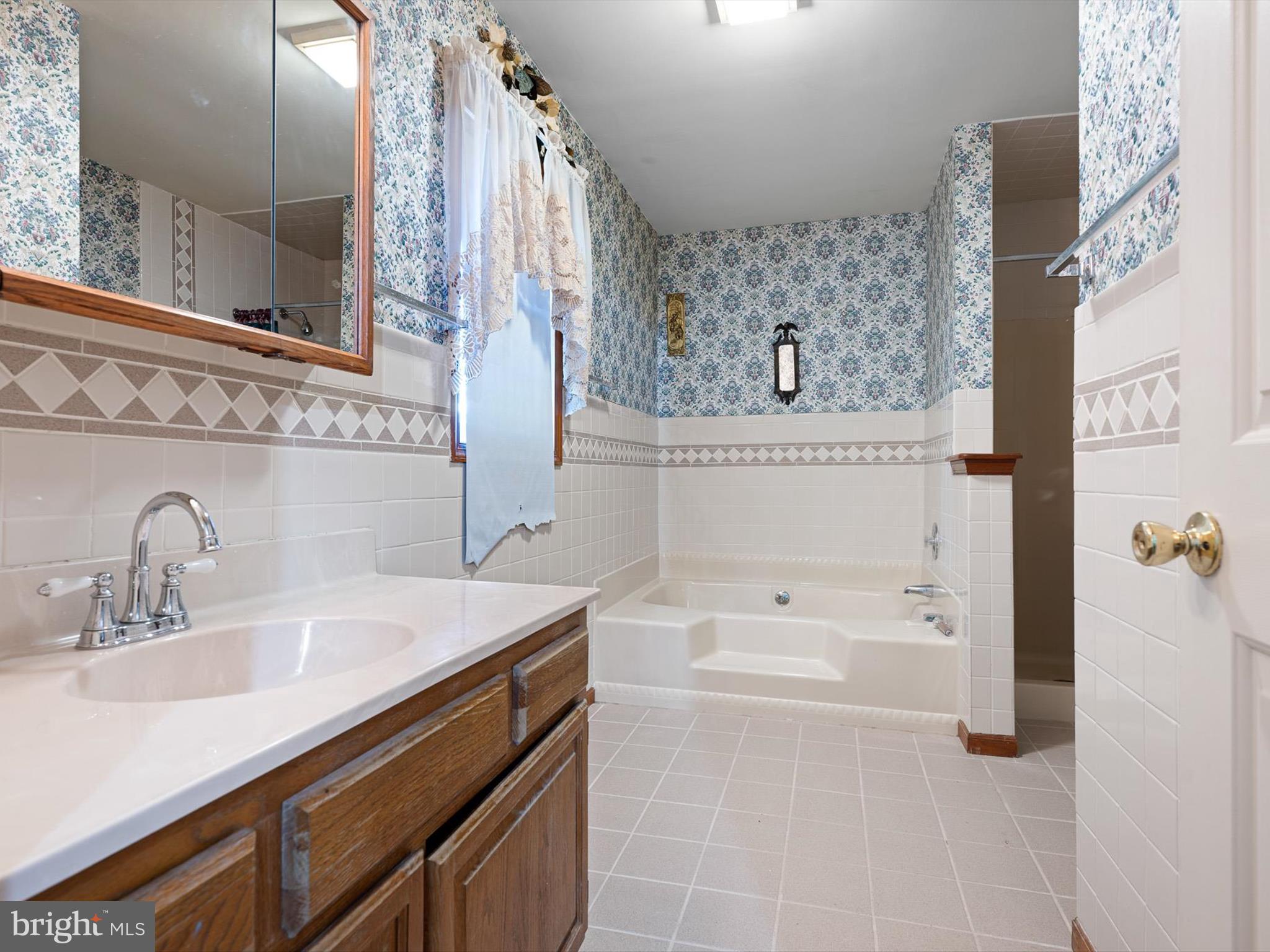16327 Old Mill Road Lewes, DE 19958 - Photo 21 of 35 a bathroom with a sink and a bathtub