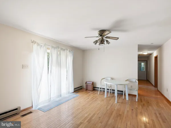 a view of a dining room with furniture and a chandelier