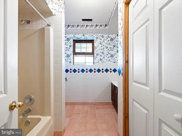 a bathroom with a tub and a shower