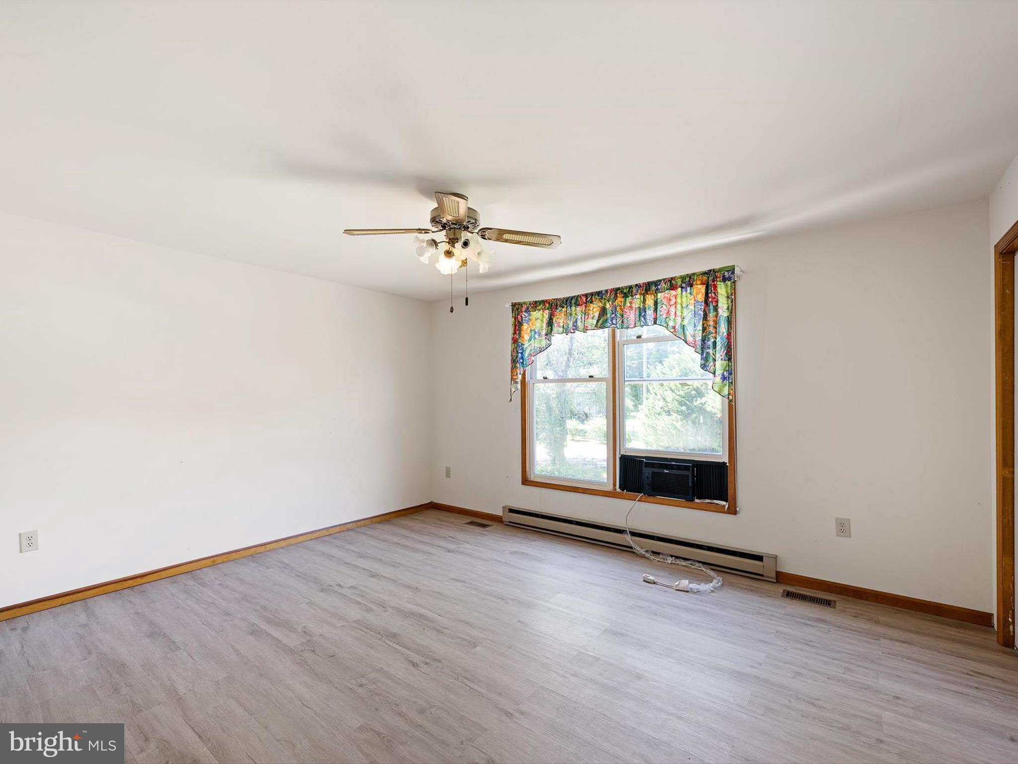 16327 Old Mill Road Lewes, DE 19958 - Photo 32 of 35 an empty room with wooden floor and windows