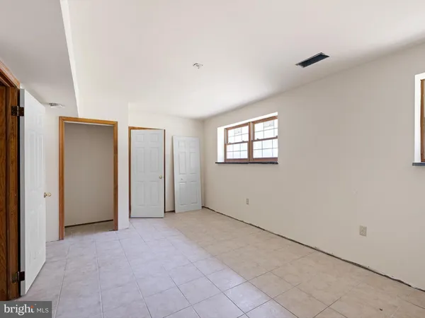 a view of an empty room with windows