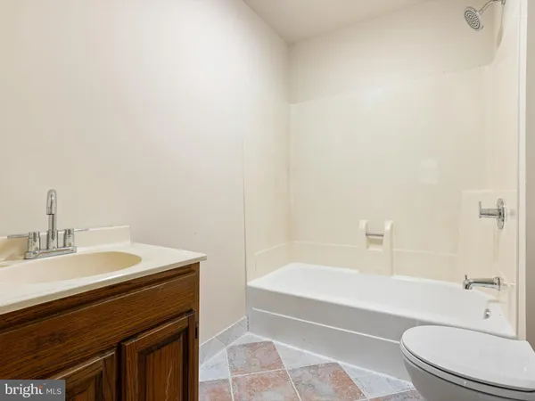 a bathroom with a sink a toilet and bathtub