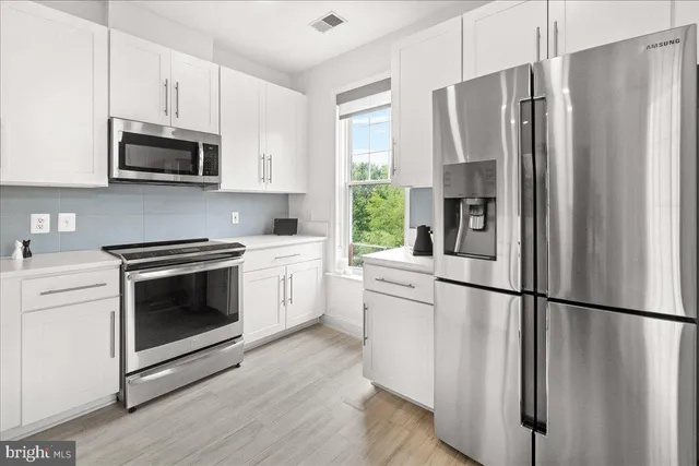 a bathroom with a double vanity sink mirror double and bathtub