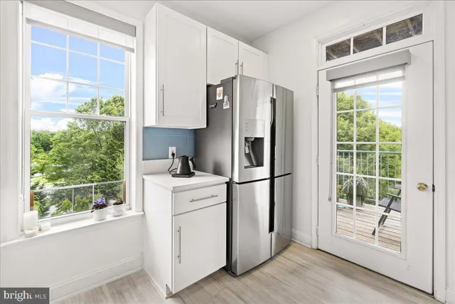 a bedroom with a bed a desk and chair next to a window