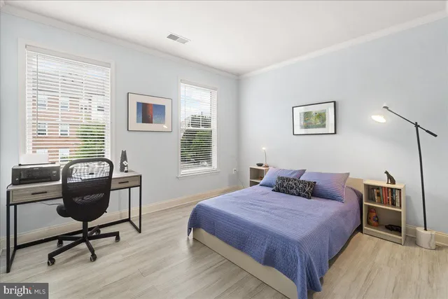 a front view of a building with a garden and plants