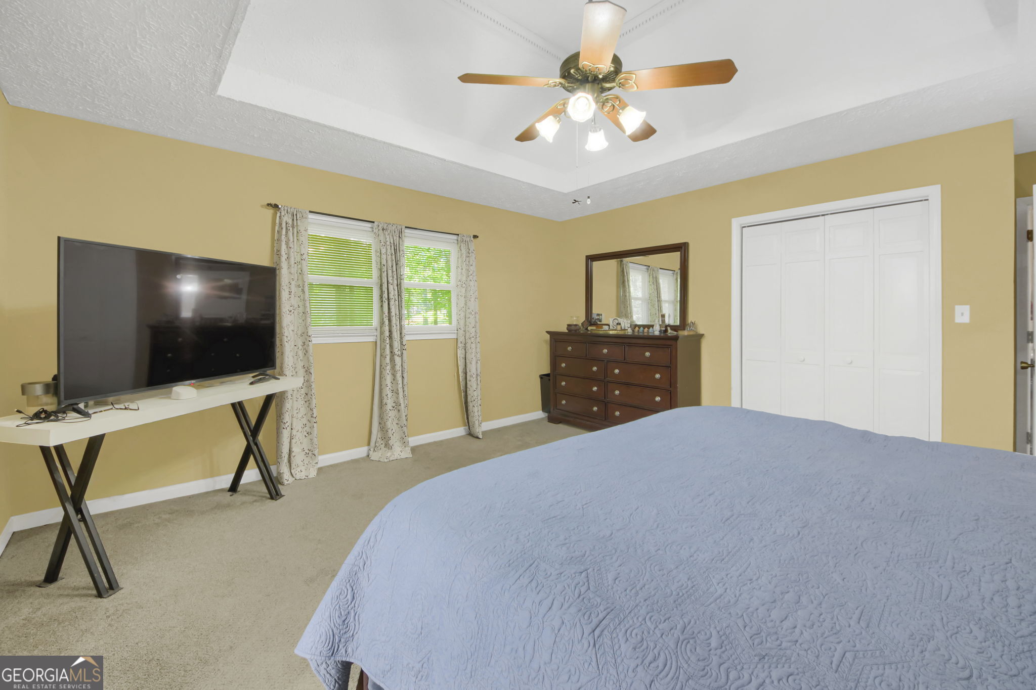 112 Bridget Drive Hampton, GA 30228 - Photo 15 of 26 a bedroom with a bed and a flat screen tv