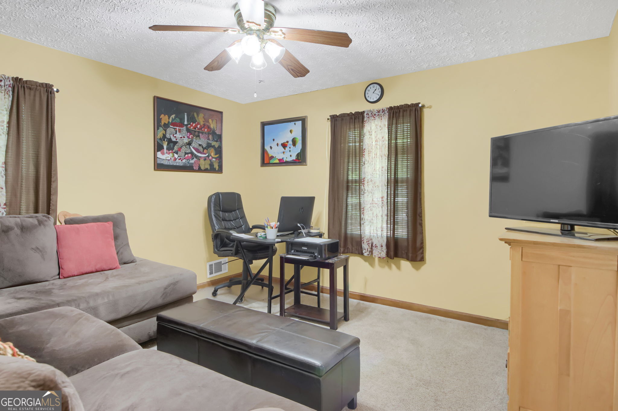 112 Bridget Drive Hampton, GA 30228 - Photo 18 of 26 a living room with furniture and a flat screen tv