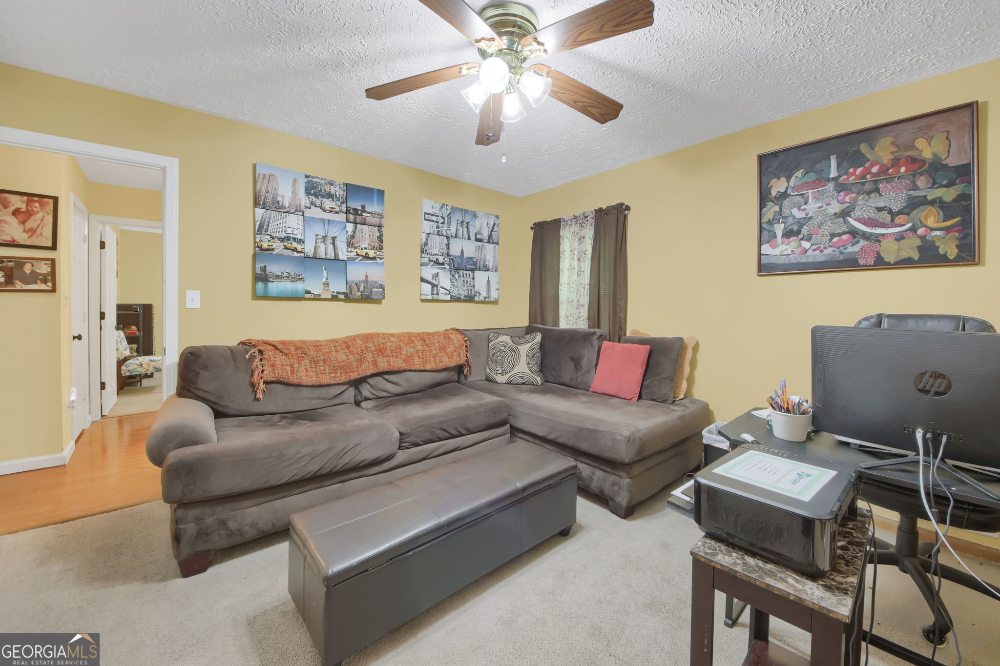 112 Bridget Drive Hampton, GA 30228 - Photo 19 of 26 a living room with furniture and a chandelier