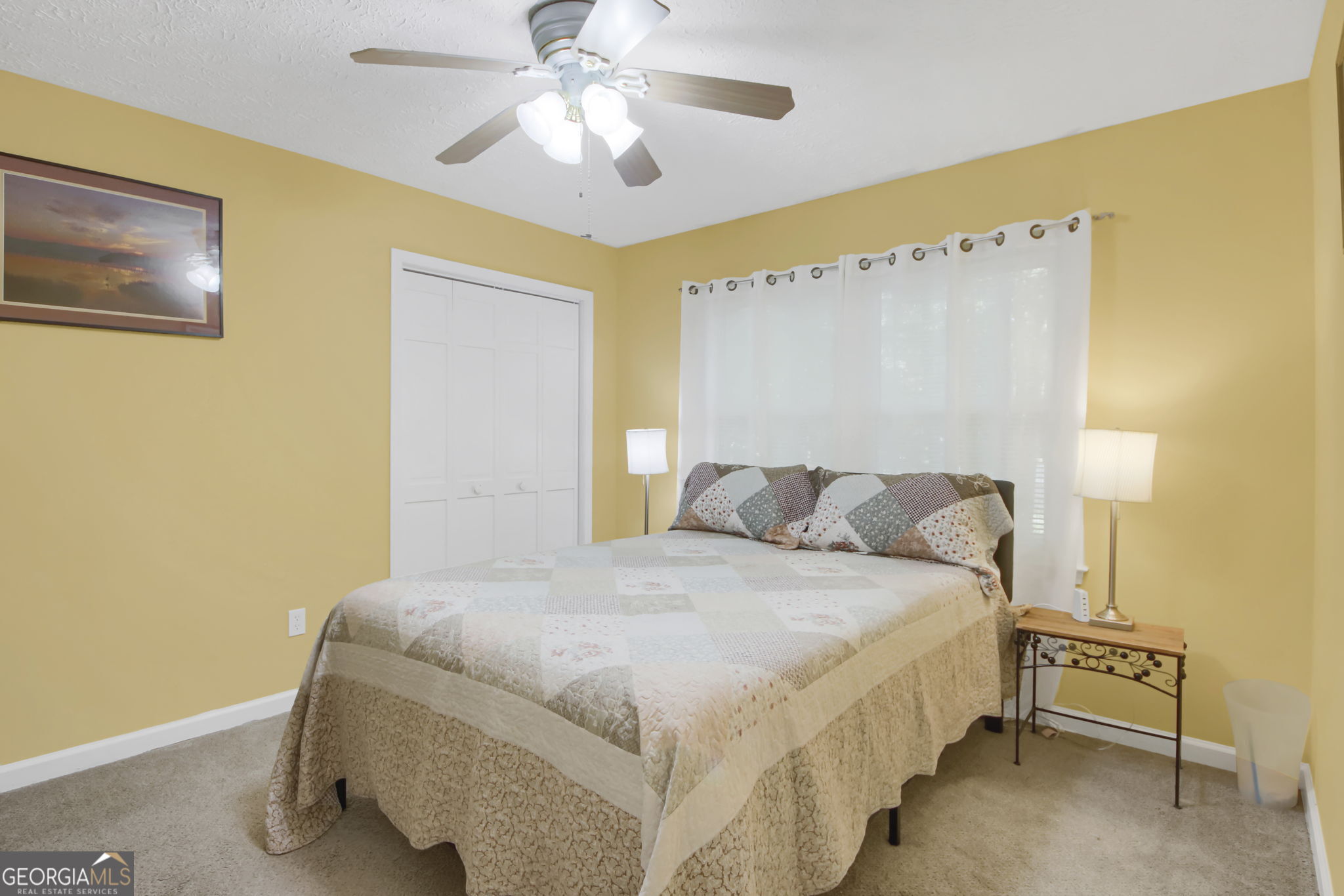 112 Bridget Drive Hampton, GA 30228 - Photo 21 of 26 a bedroom with a bed and a chandelier
