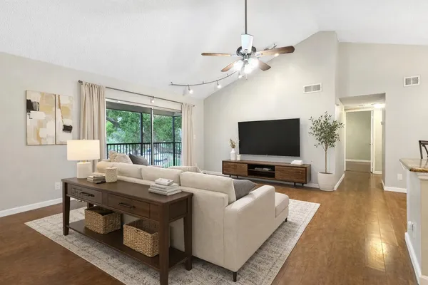 a living room with furniture and a flat screen tv
