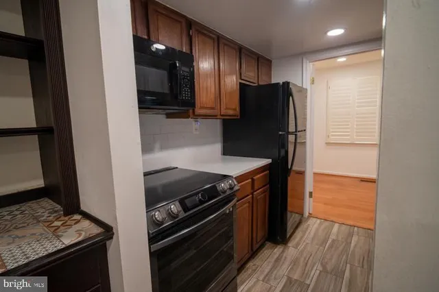a kitchen with stainless steel appliances granite countertop a refrigerator and a stove