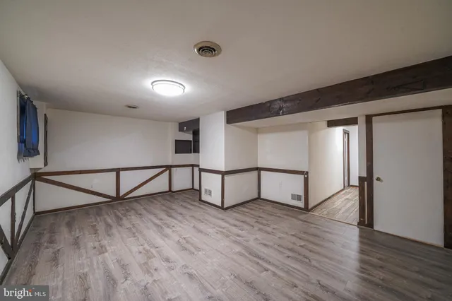 a view of staircase and kitchen with wooden floor