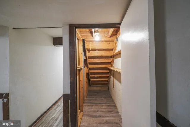 a view of a hallway with wooden walls and entryway
