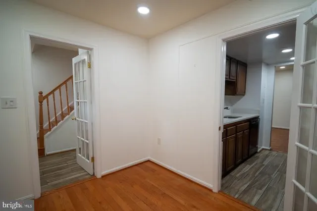 a view of a hallway with wooden floor and staircase