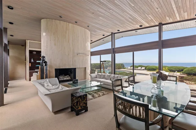 a living room with furniture and large windows