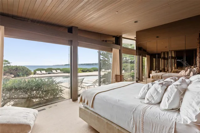 a large bedroom with a large bed and a balcony