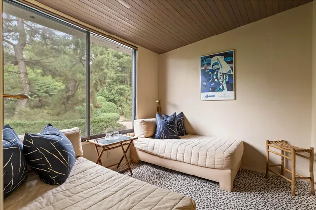 a bedroom with furniture and a large window