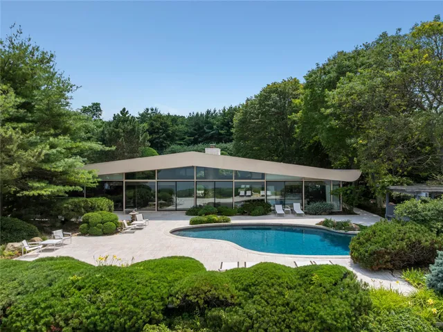 a view of a house with swimming pool and garden