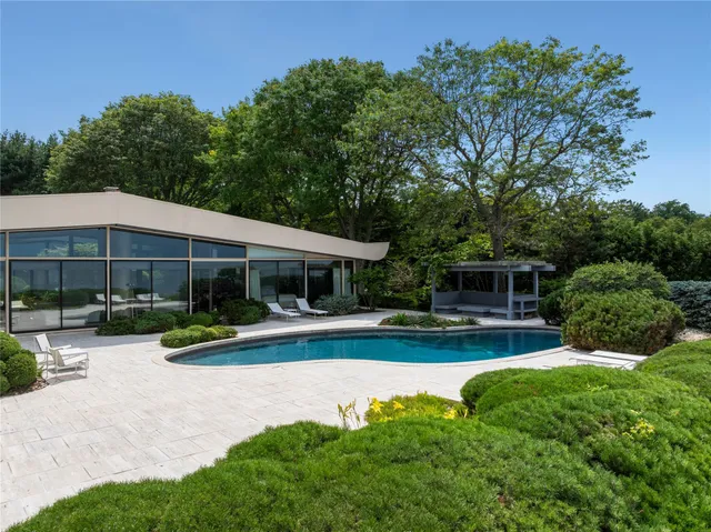 a view of a house with a yard patio and a garden