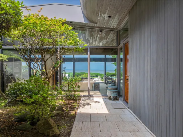 a view of a porch with dining table and chairs