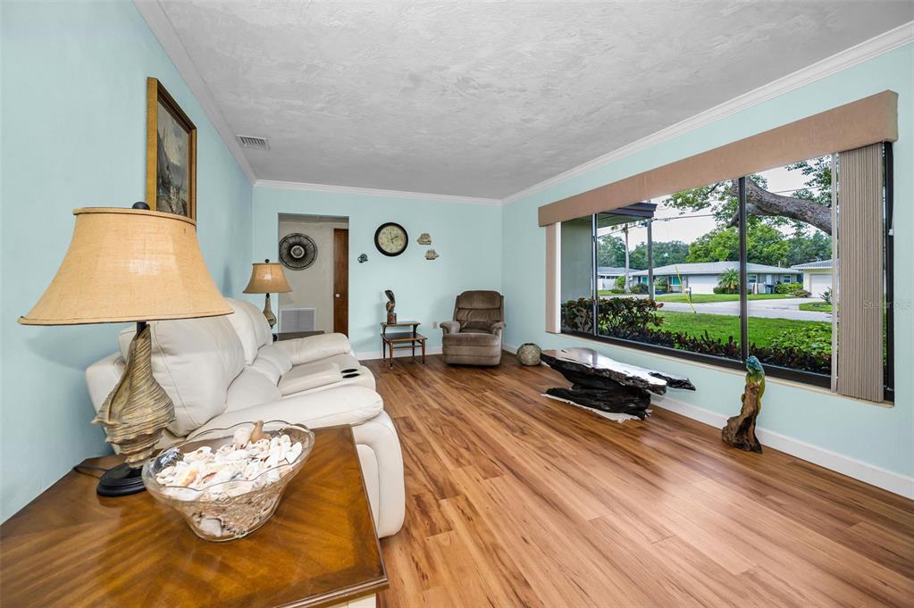 409 Graham Drive Clearwater, FL 33765 - Photo 19 of 75 a living room with furniture and a flat screen tv