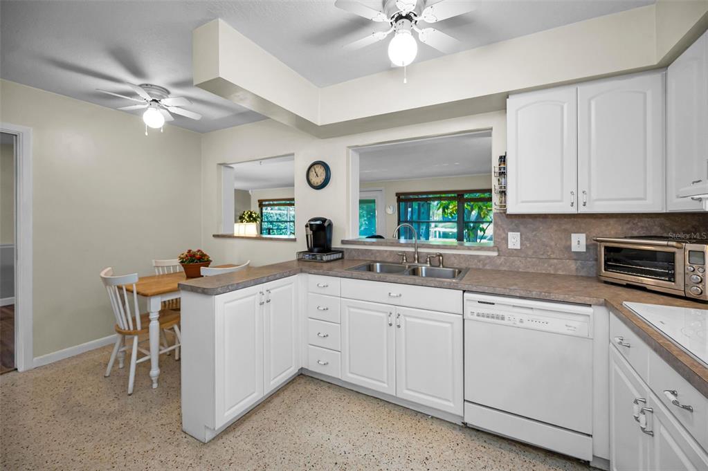 409 Graham Drive Clearwater, FL 33765 - Photo 28 of 75 a kitchen with a sink cabinets and window