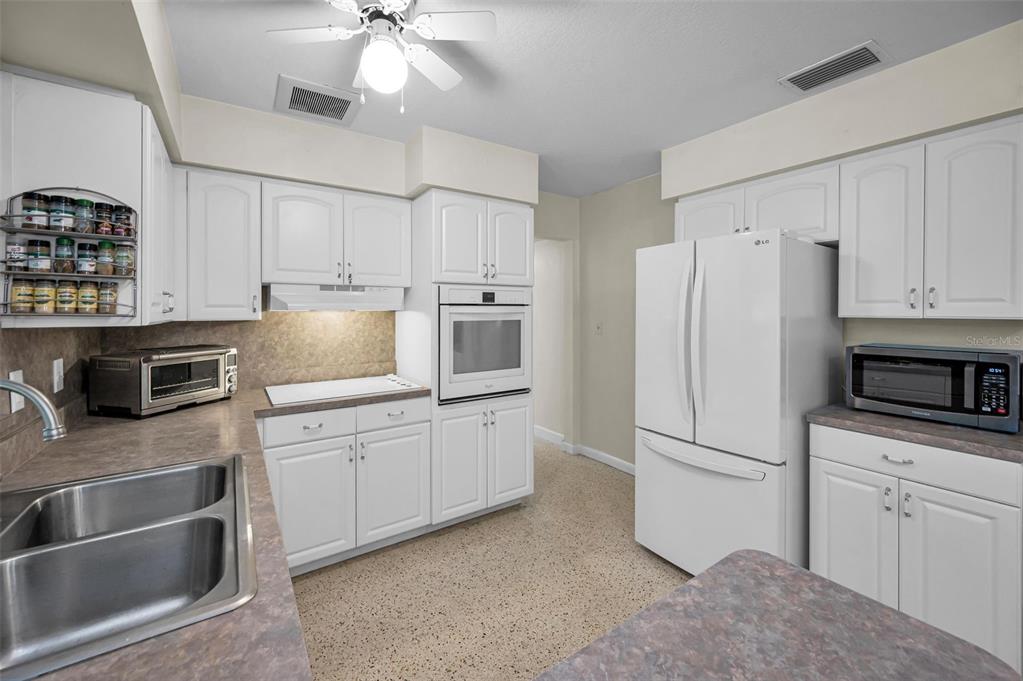 409 Graham Drive Clearwater, FL 33765 - Photo 30 of 75 a kitchen with cabinets stainless steel appliances and a counter space