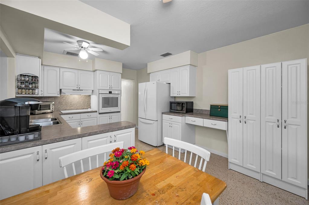 409 Graham Drive Clearwater, FL 33765 - Photo 32 of 75 a kitchen with stainless steel appliances kitchen island granite countertop a refrigerator and microwave