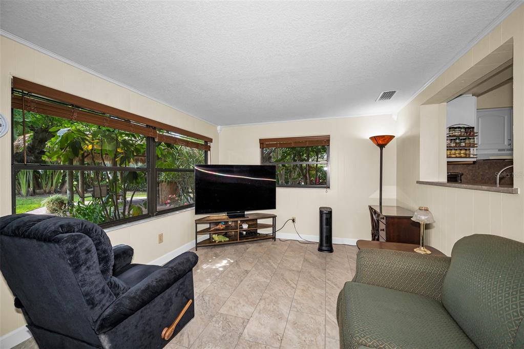 409 Graham Drive Clearwater, FL 33765 - Photo 35 of 75 a living room with furniture tv and a large window