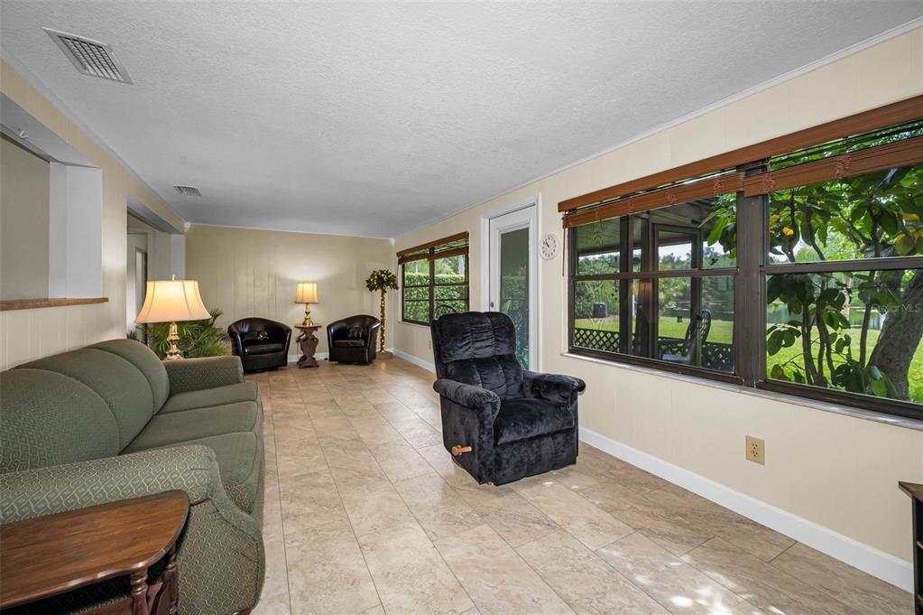 409 Graham Drive Clearwater, FL 33765 - Photo 36 of 75 a living room with furniture and large windows