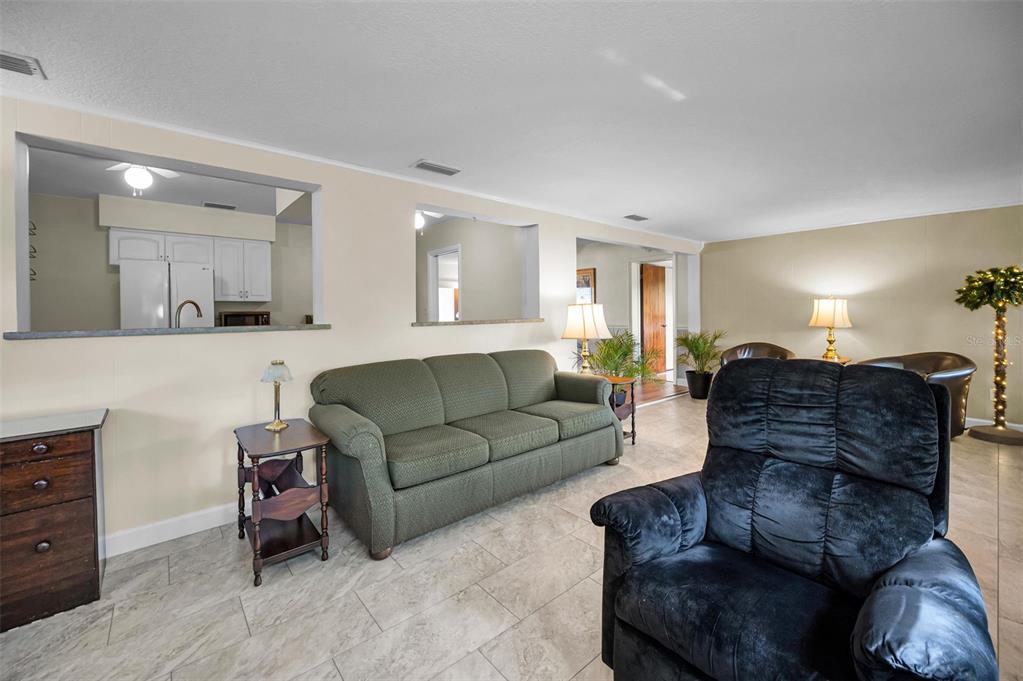 409 Graham Drive Clearwater, FL 33765 - Photo 38 of 75 a living room with furniture a couch and dresser