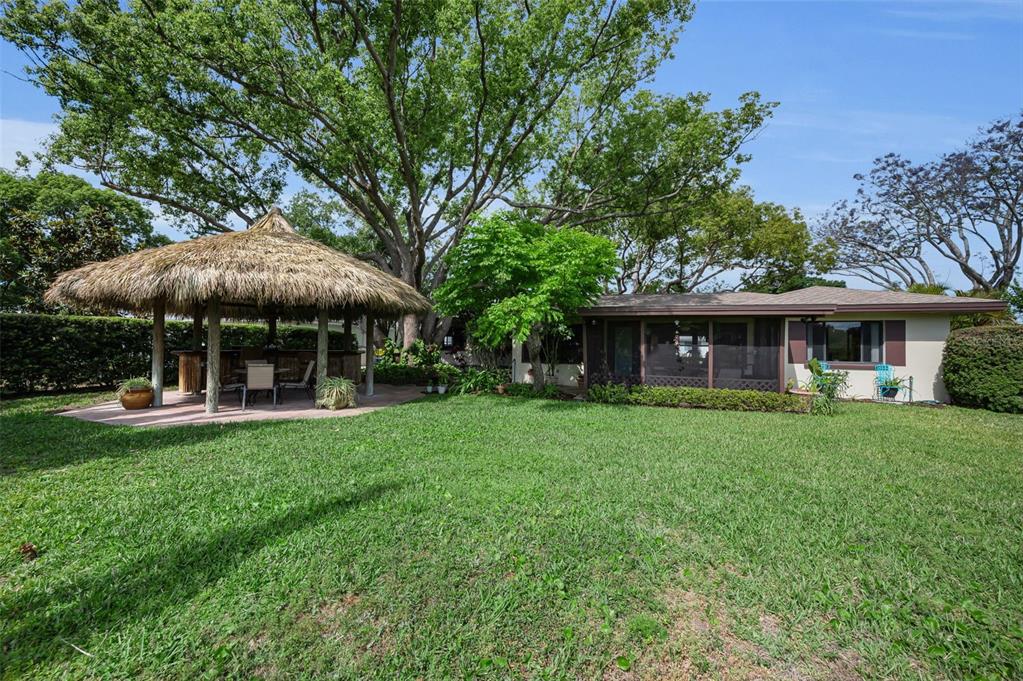 409 Graham Drive Clearwater, FL 33765 - Photo 4 of 75 a front view of a house with a garden
