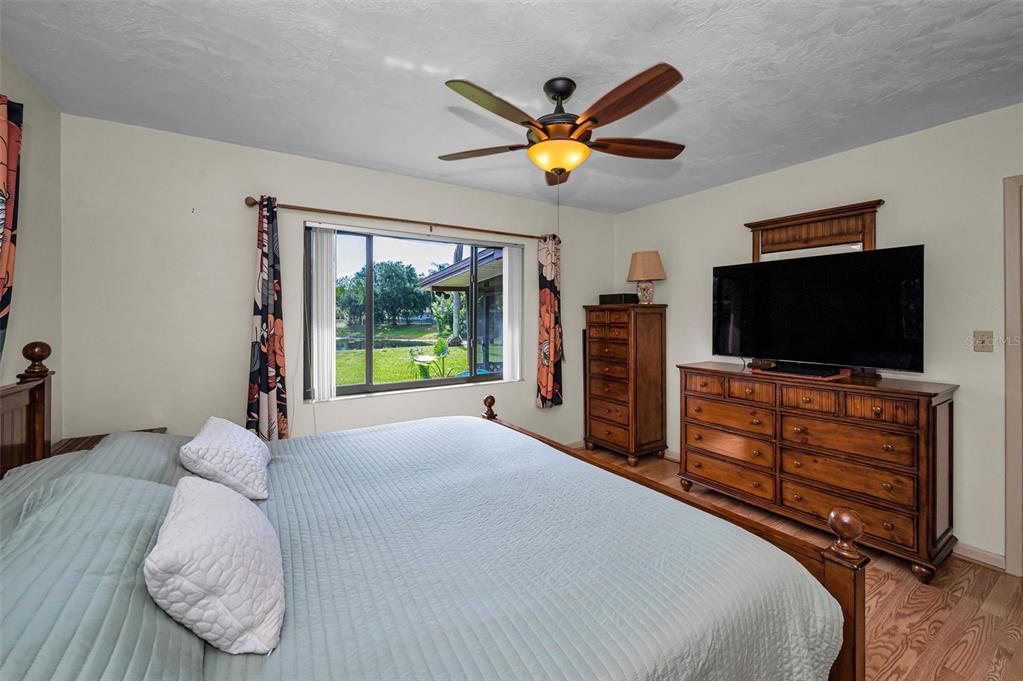 409 Graham Drive Clearwater, FL 33765 - Photo 41 of 75 a bedroom with a bed and a flat screen tv