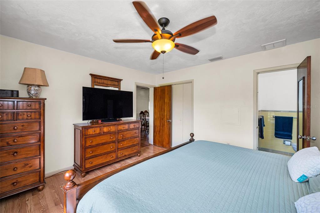 409 Graham Drive Clearwater, FL 33765 - Photo 42 of 75 a bedroom with furniture and a flat screen tv