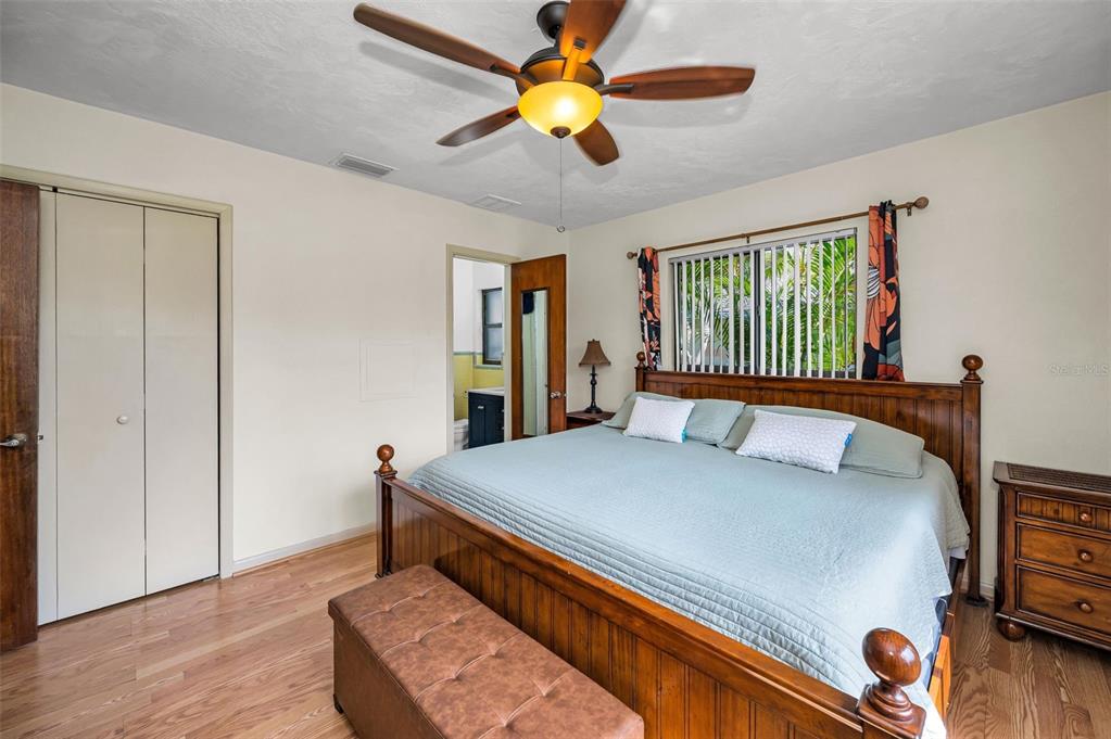 409 Graham Drive Clearwater, FL 33765 - Photo 43 of 75 a bed room with a bed and a chandelier