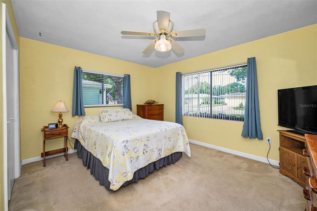 409 Graham Drive Clearwater, FL 33765 - Photo 45 of 75 a spacious bedroom with a bed and a flat screen tv