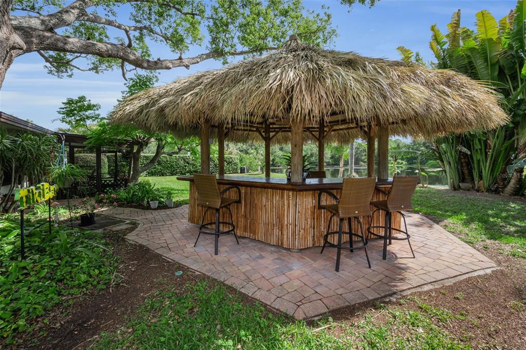 409 Graham Drive Clearwater, FL 33765 - Photo 58 of 75 a view of patio with chairs and table under an umbrella with a barbeque