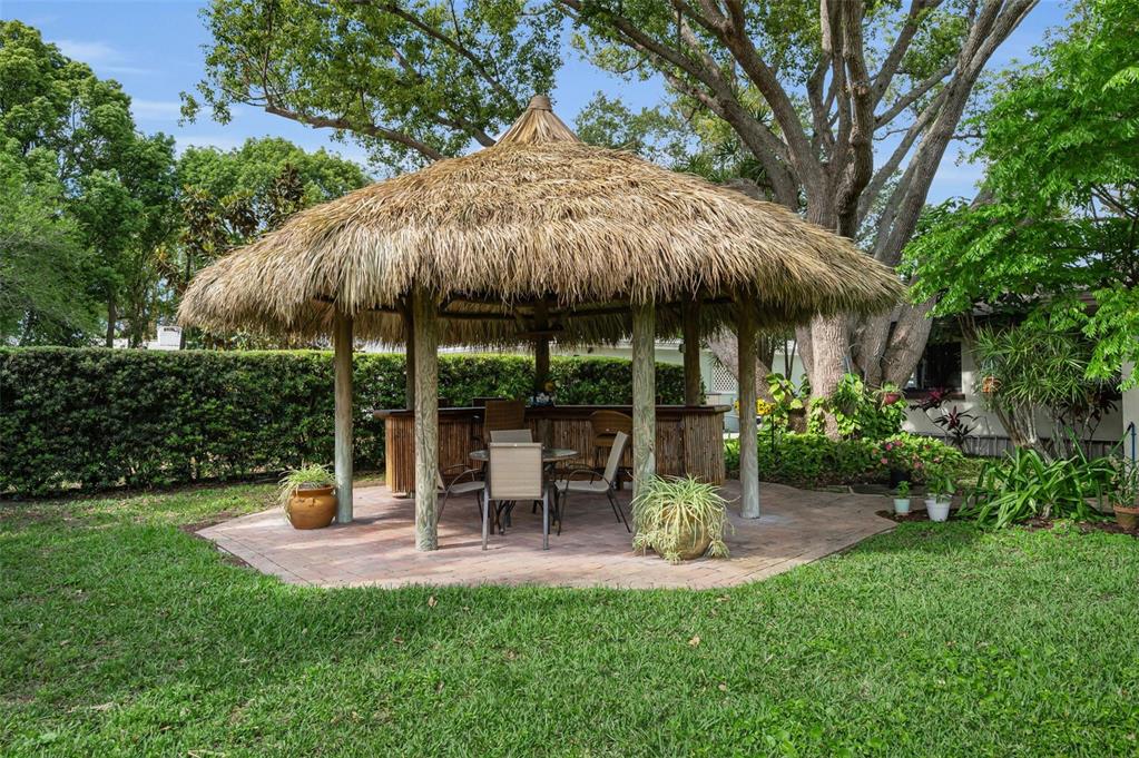 409 Graham Drive Clearwater, FL 33765 - Photo 6 of 75 a view of a table and chairs under an umbrella