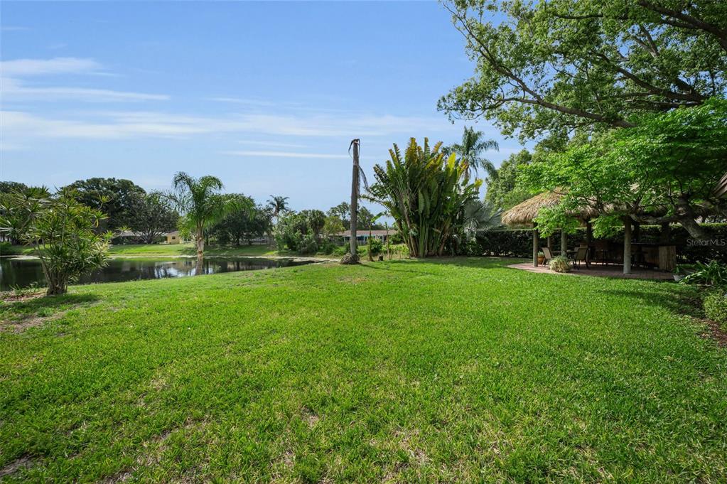 409 Graham Drive Clearwater, FL 33765 - Photo 64 of 75 a view of yard with swimming pool and green space