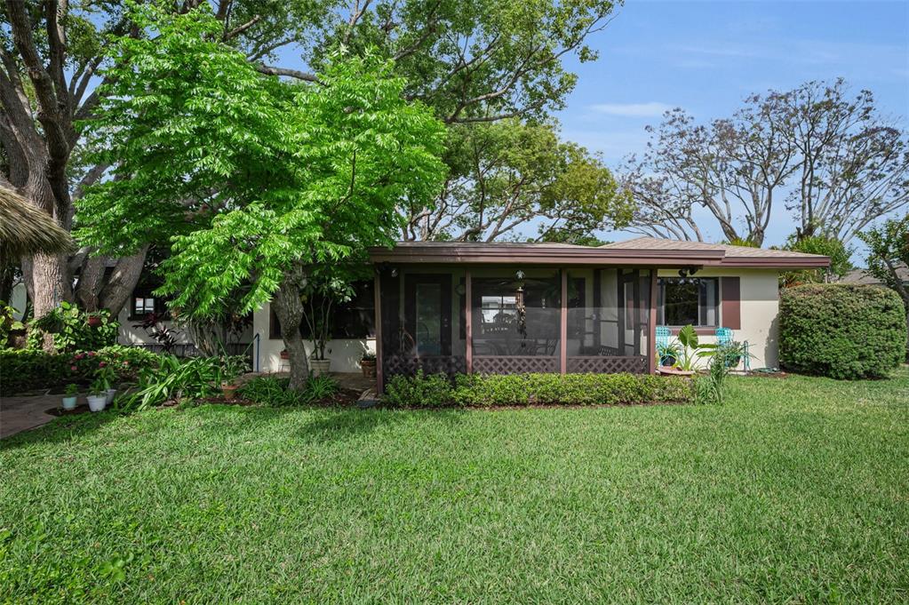 409 Graham Drive Clearwater, FL 33765 - Photo 73 of 75 a view of a house with a yard and sitting area